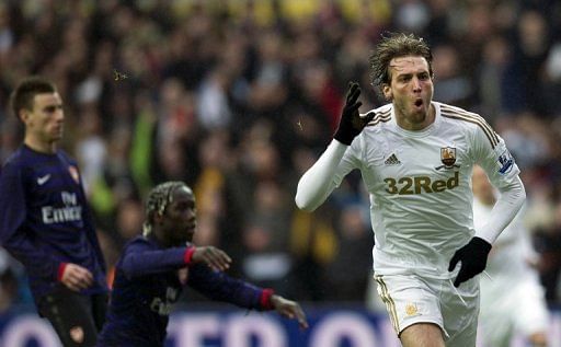 Swansea City's Michu (R) celebrates after scoring the opening goal against Arsenal in the FA Cup on January 6, 2013